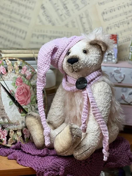 Handmade white polar bear in a sleeping cap